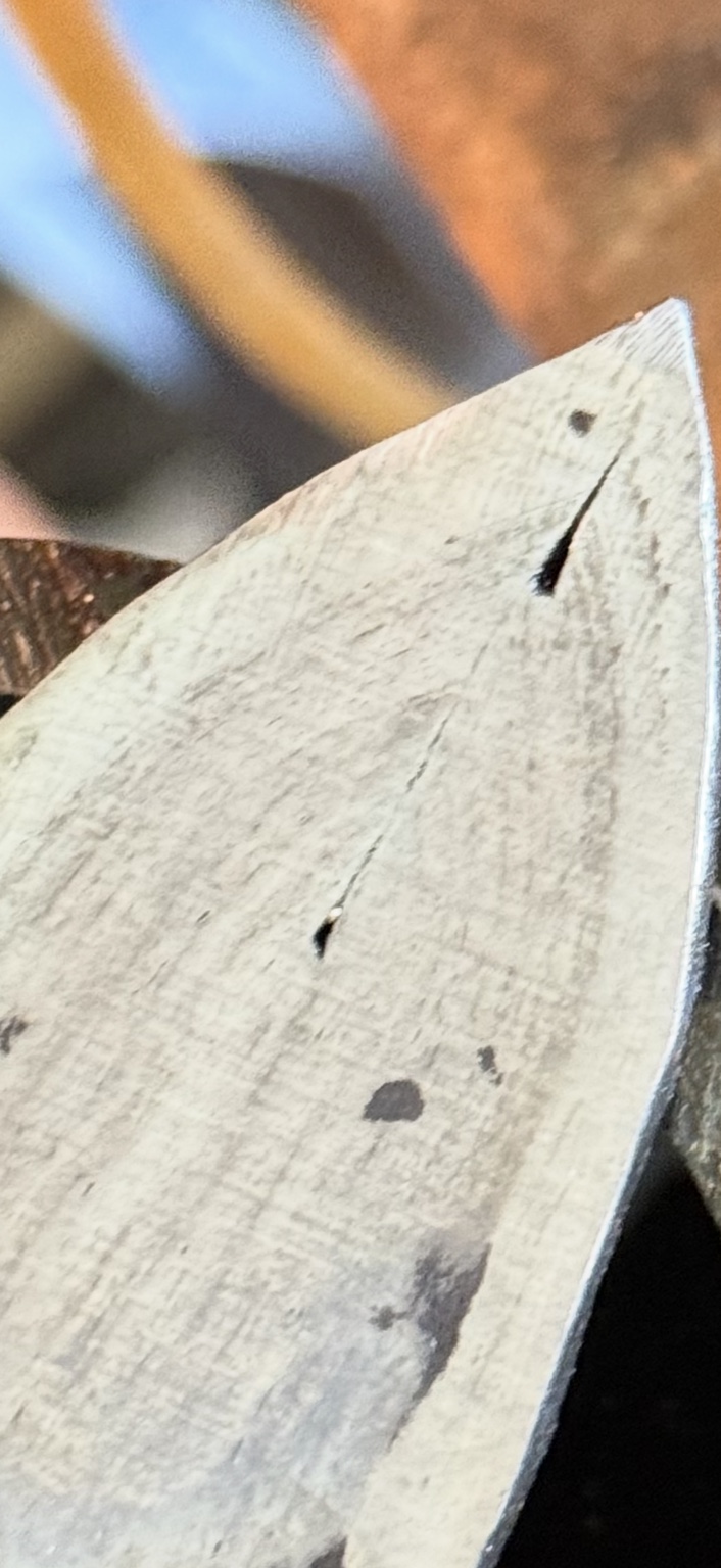 Close-up of a dark split near the blade point following a further fish-mouth welding attempt