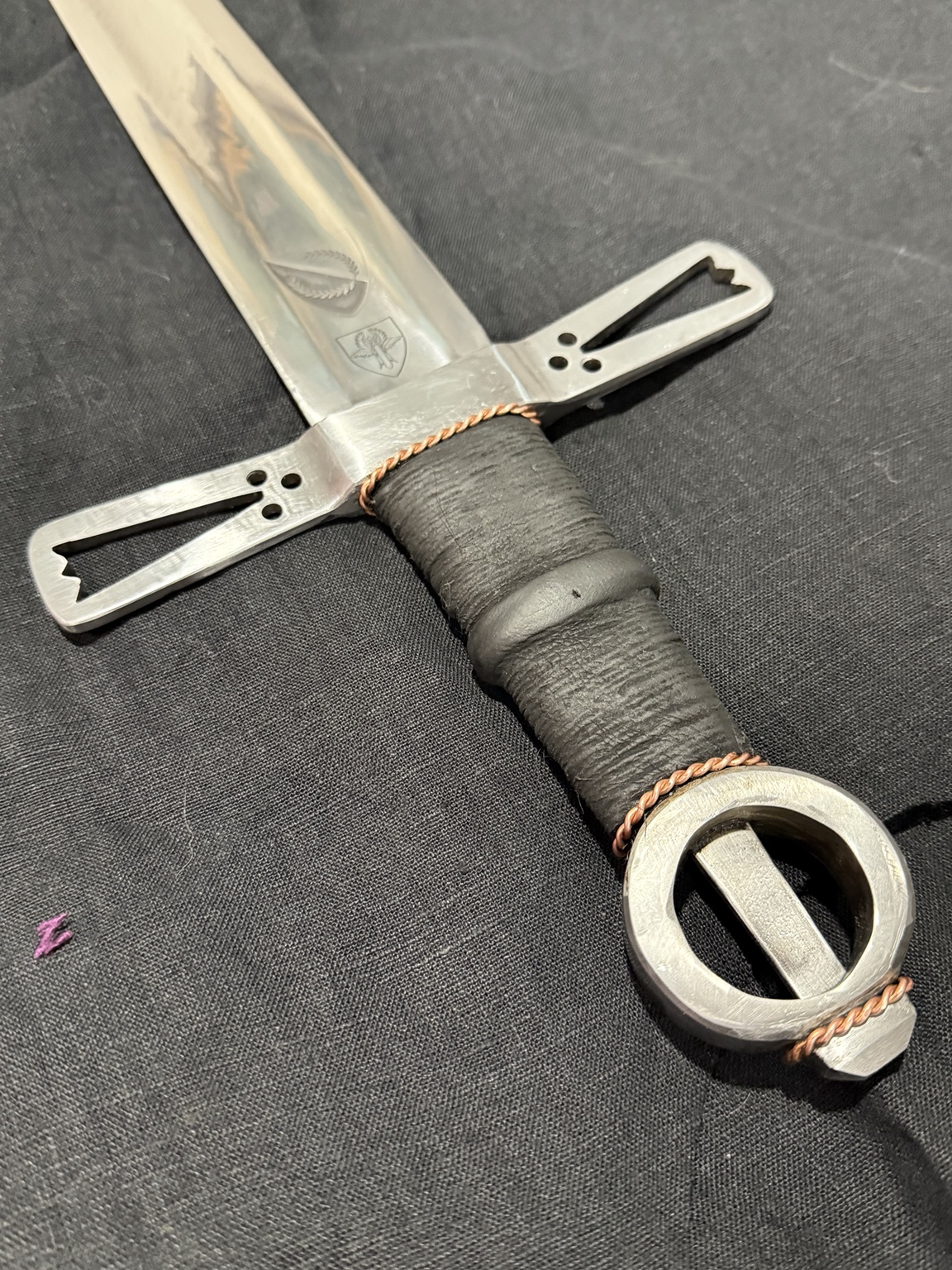 Loch Salann hilt and ring pommel resting on black cloth