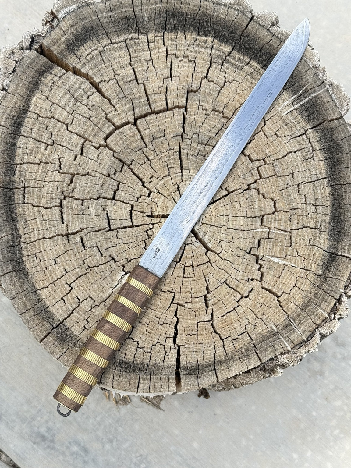 Complete Viking Age Scandinavian long knife with wire-wrapped grip on a stump