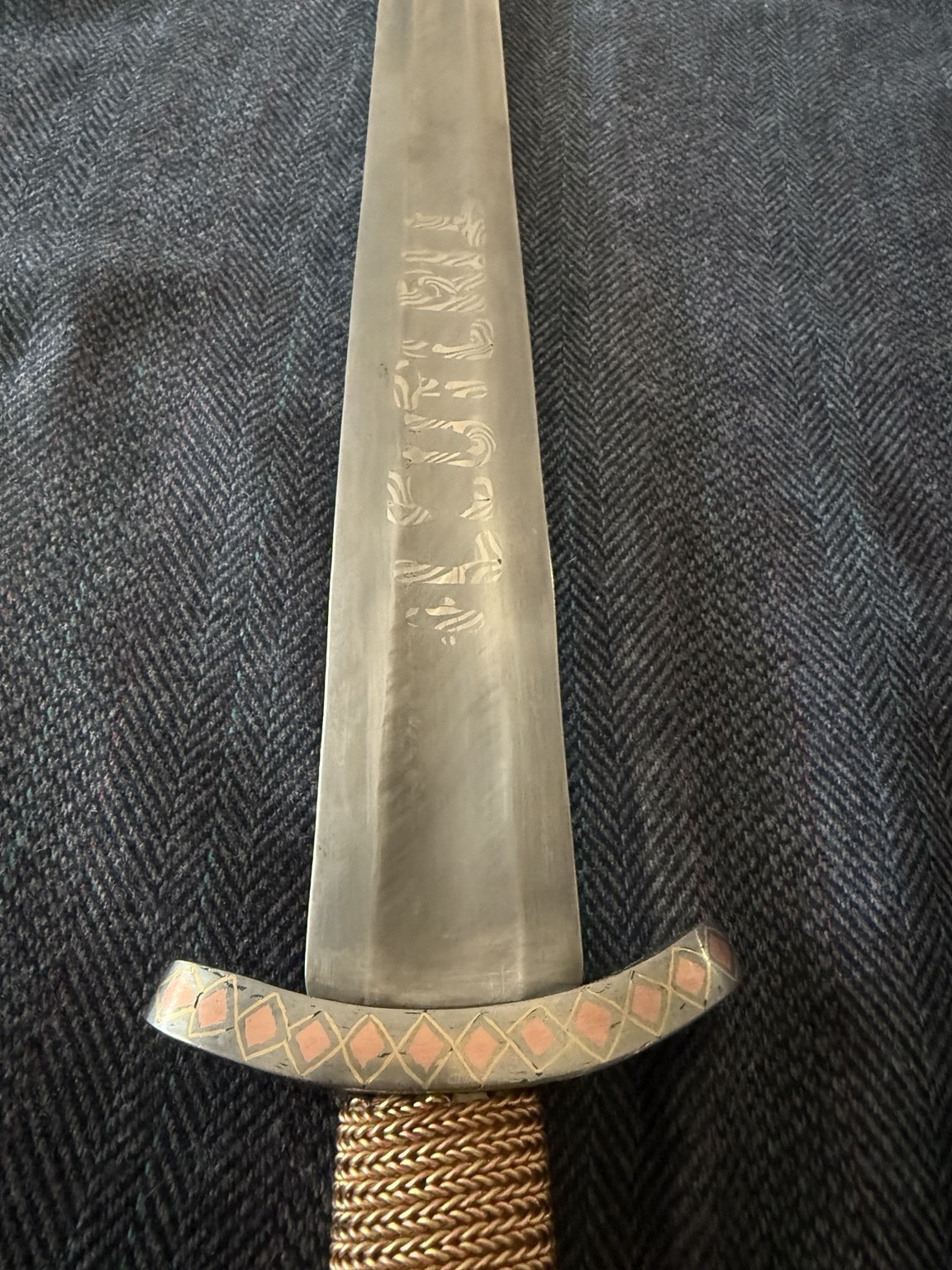 Close view of blade inscription and inlaid curved guard