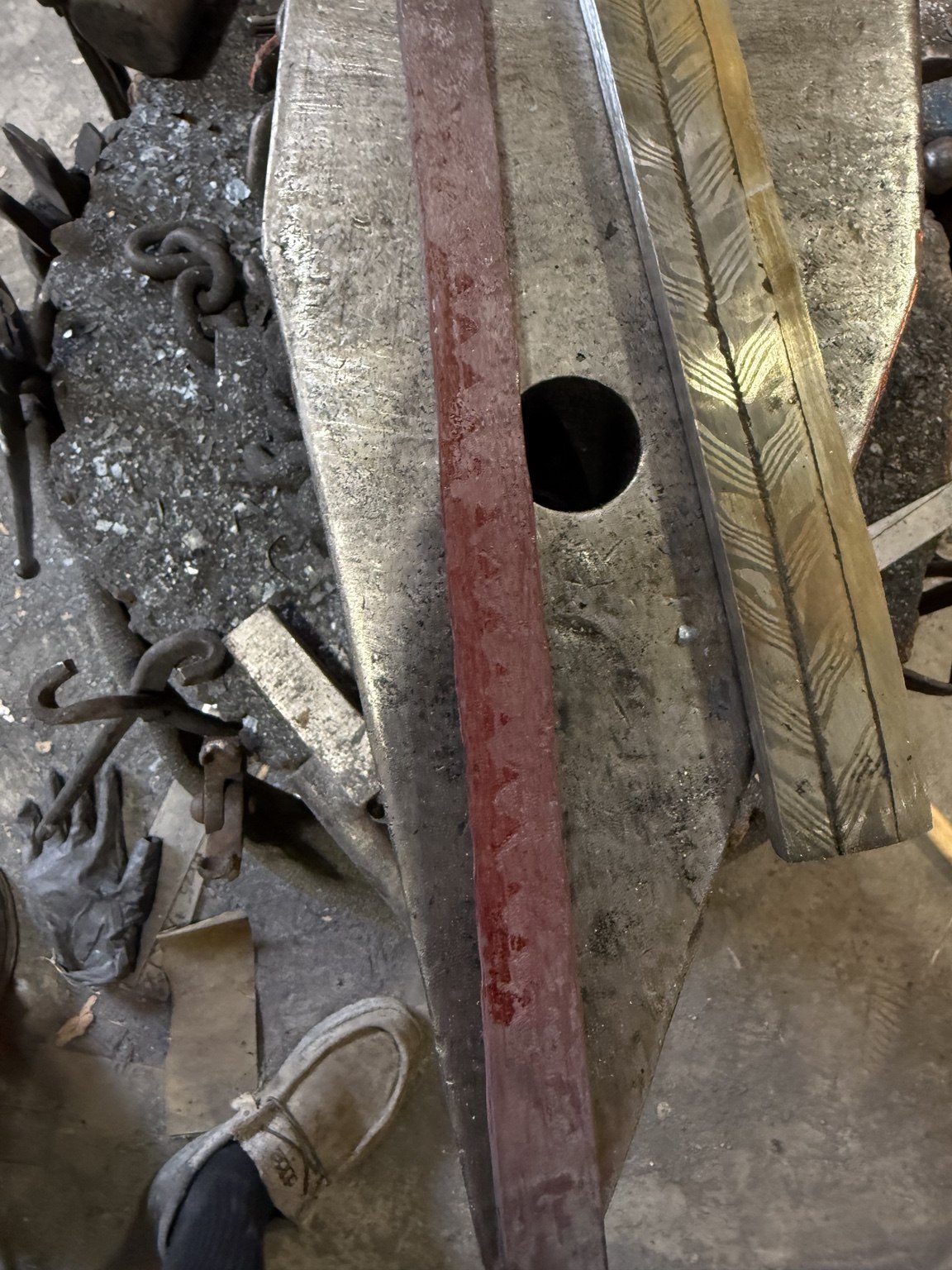Red-hot wolf-tooth assembly immediately after forge welding, showing contrast between wrought iron and 1084 steel