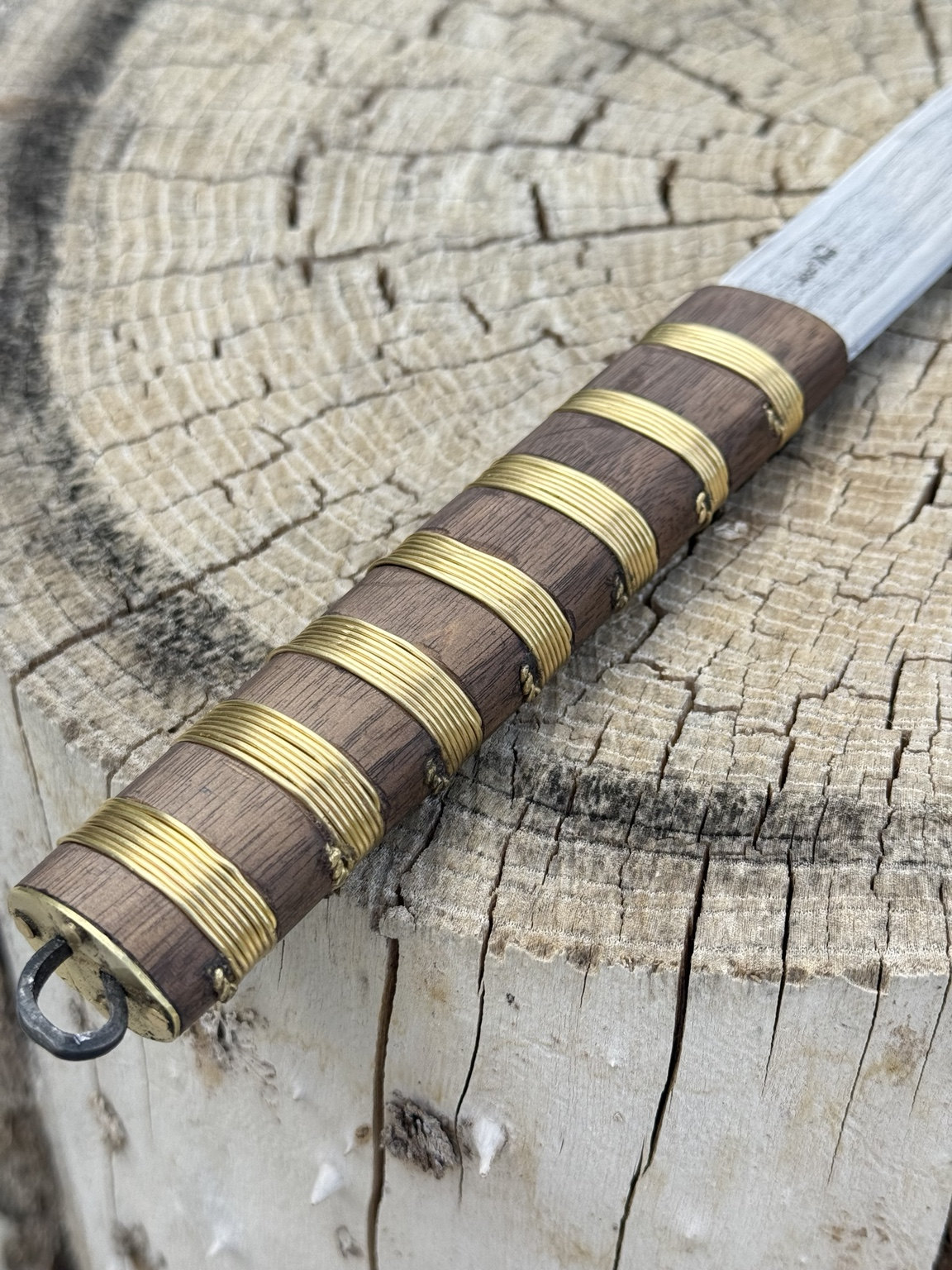 Detail of the oak handle with seven brass wire bands and suspension ring